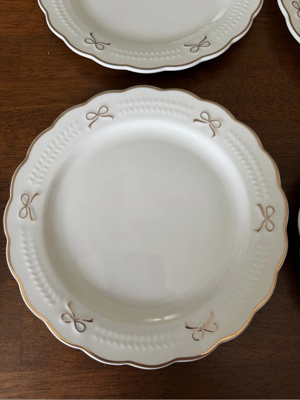 Set of White Scalloped Dinner Plates with Gold Bow Details